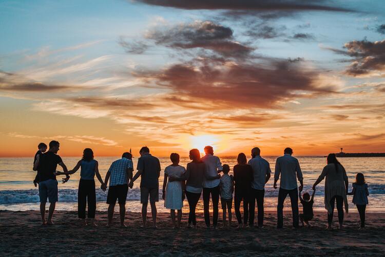 Family on beach during sunset